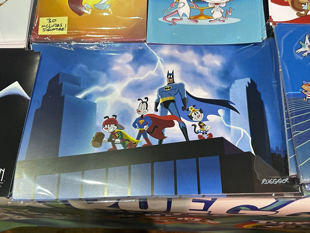 Animaniacs artwork displayed at Tom Ruegger's booth during FanExpo Chicago 2025.